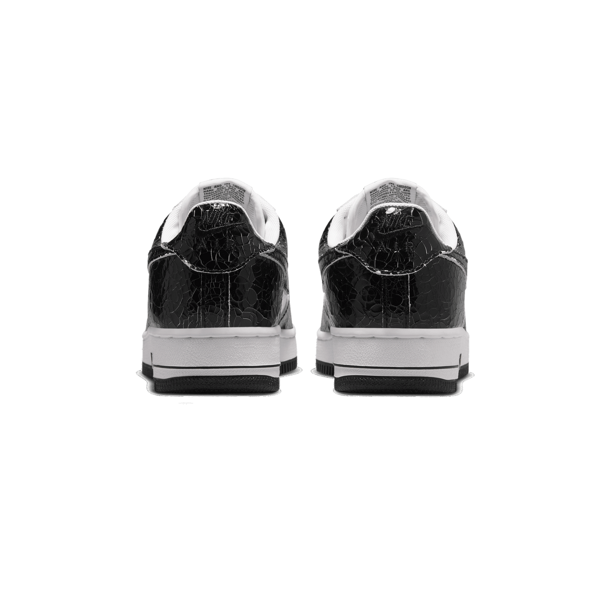 Rear view of a pair of black Nike Air Force 1 Low sneakers with a cracked, crocodile-textured leather finish and white midsoles with black outsoles