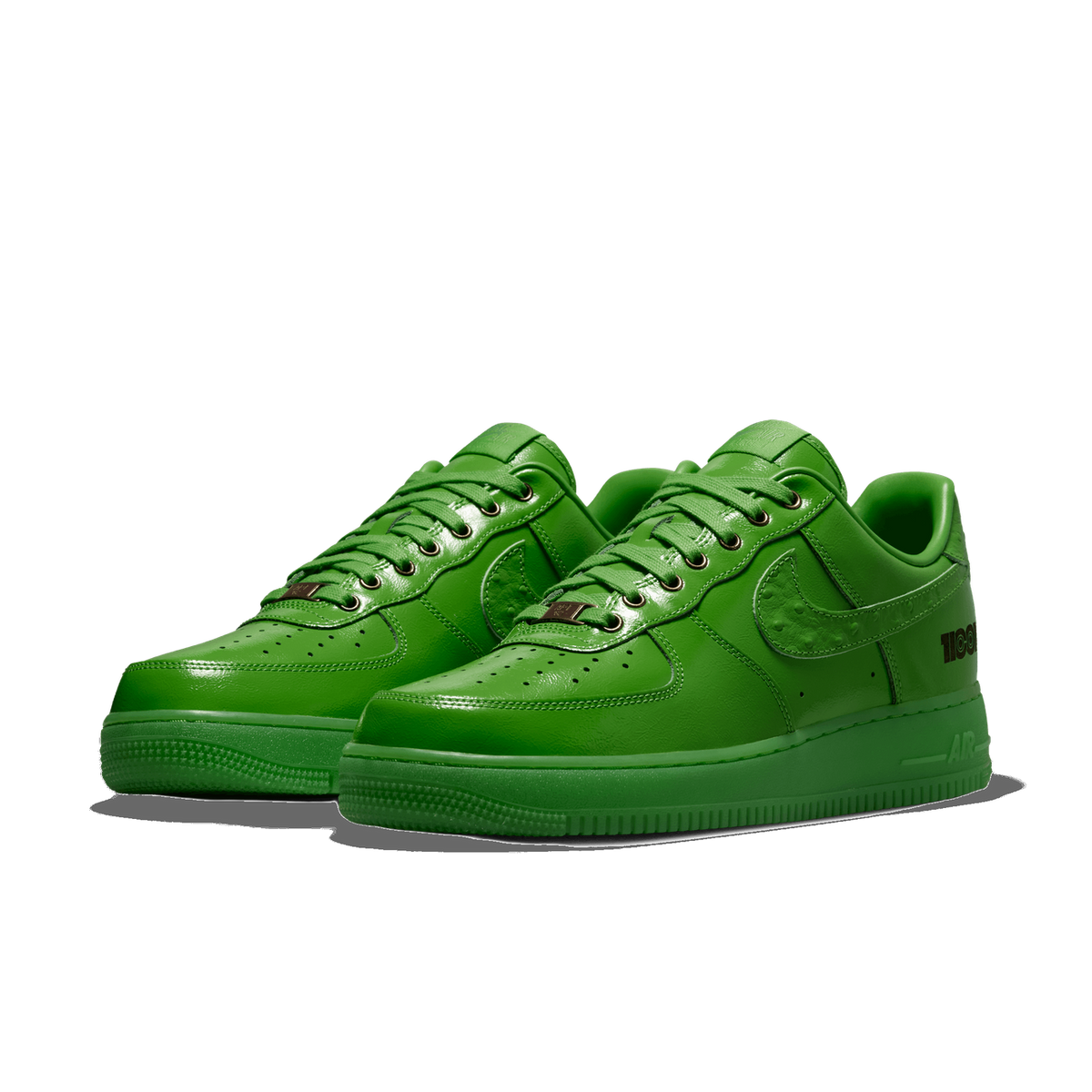 Pair of all-green Nike Air Force 1 Low sneakers with textured swoosh and heel branding, angled toward the left