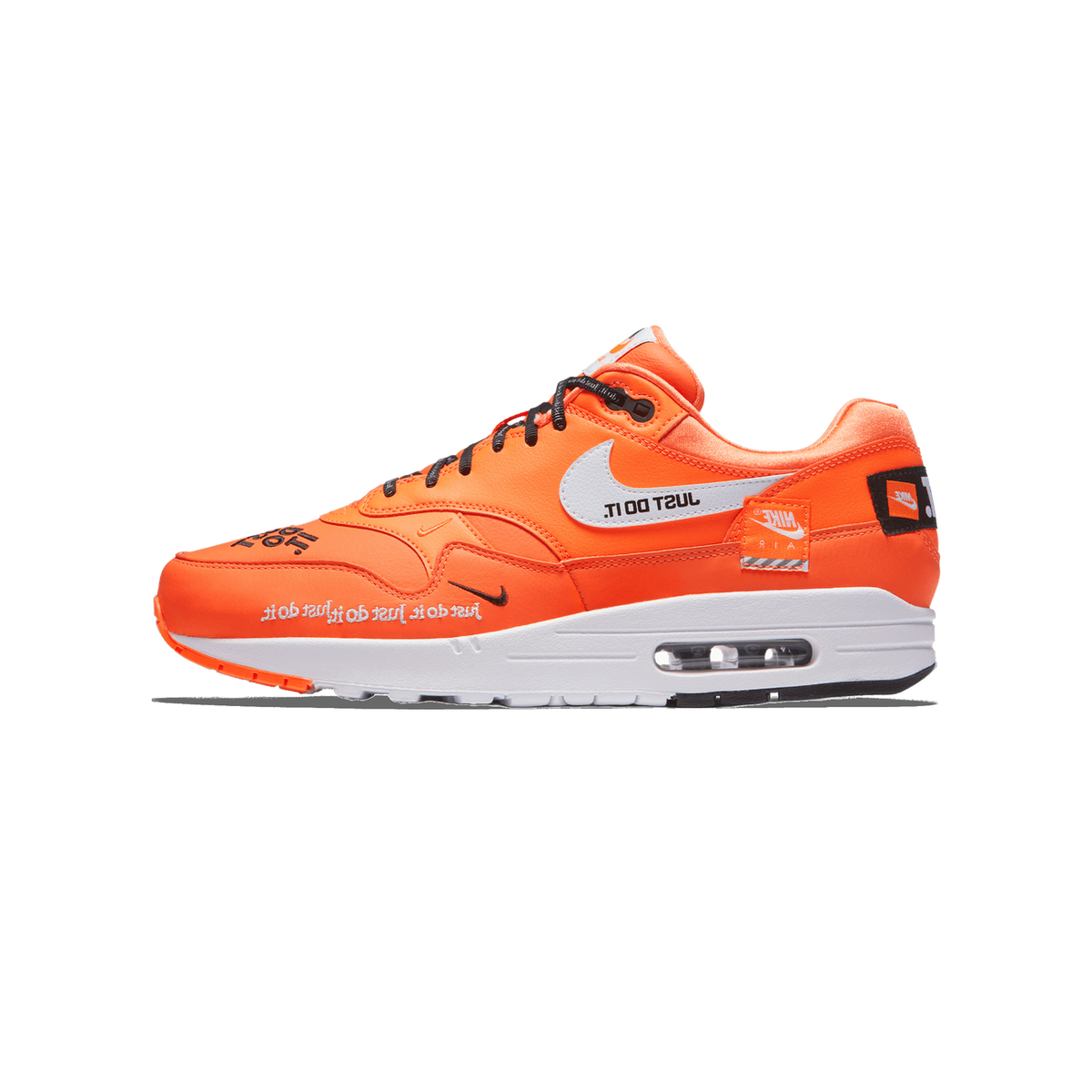 Side profile of a single orange Nike Air Max 1 sneaker with the toe pointing right, showing the lateral side with white Swoosh and 'JUST DO IT.' text, black laces, a white midsole with visible Air unit, and a black heel tab.