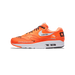 Side profile of a single orange Nike Air Max 1 sneaker with the toe pointing right, showing the lateral side with white Swoosh and 'JUST DO IT.' text, black laces, a white midsole with visible Air unit, and a black heel tab.