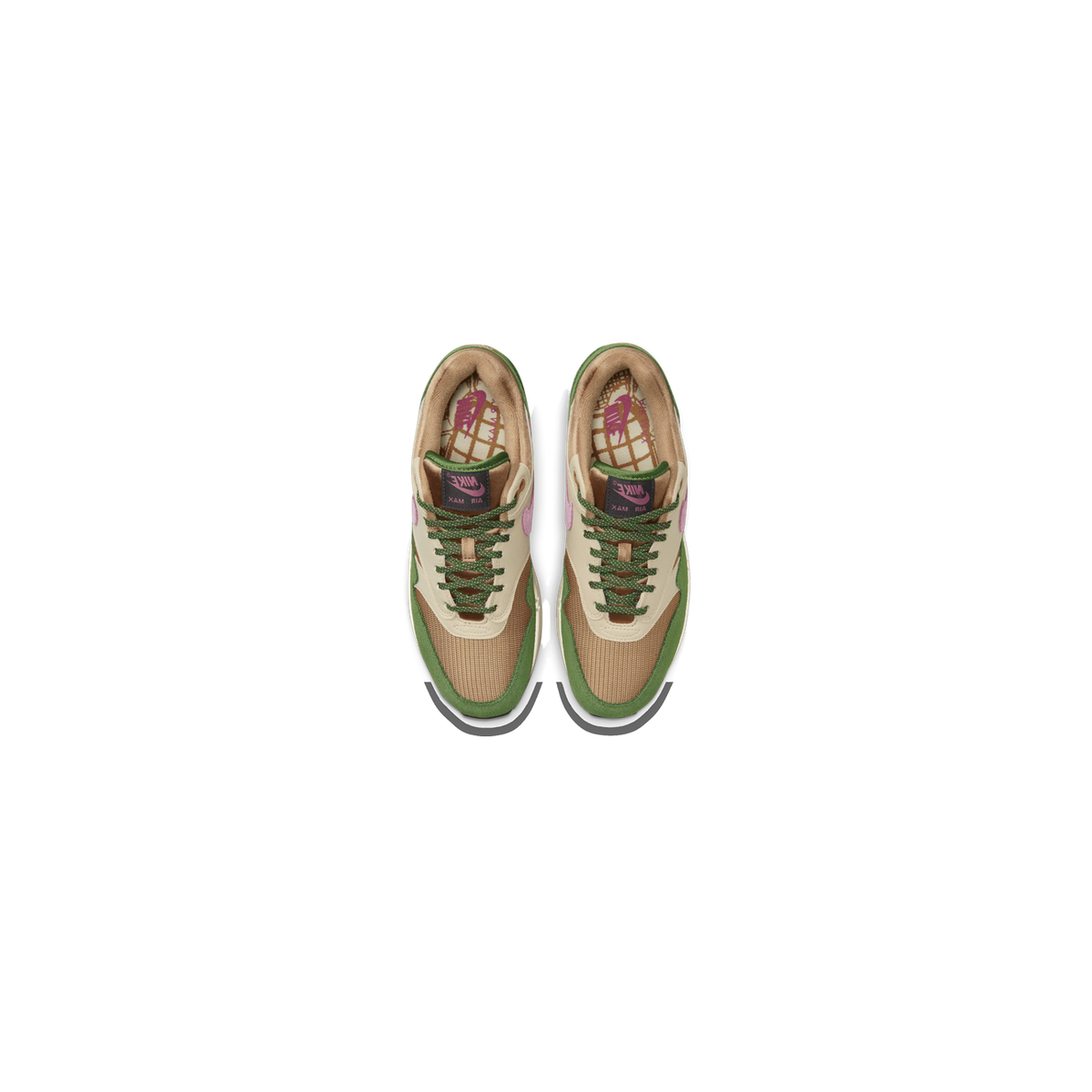 Top-down view of a pair of Nike Air Max 1 sneakers in green, tan, and brown with pink Nike branding on the tongue and lining and green laces