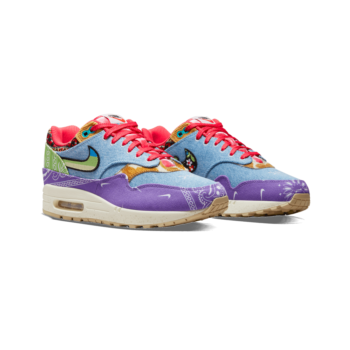 Pair of Nike Air Max 1 SP Concepts Far Out sneakers in denim blue, purple bandana print, with green and pink accents, angled toward the left front