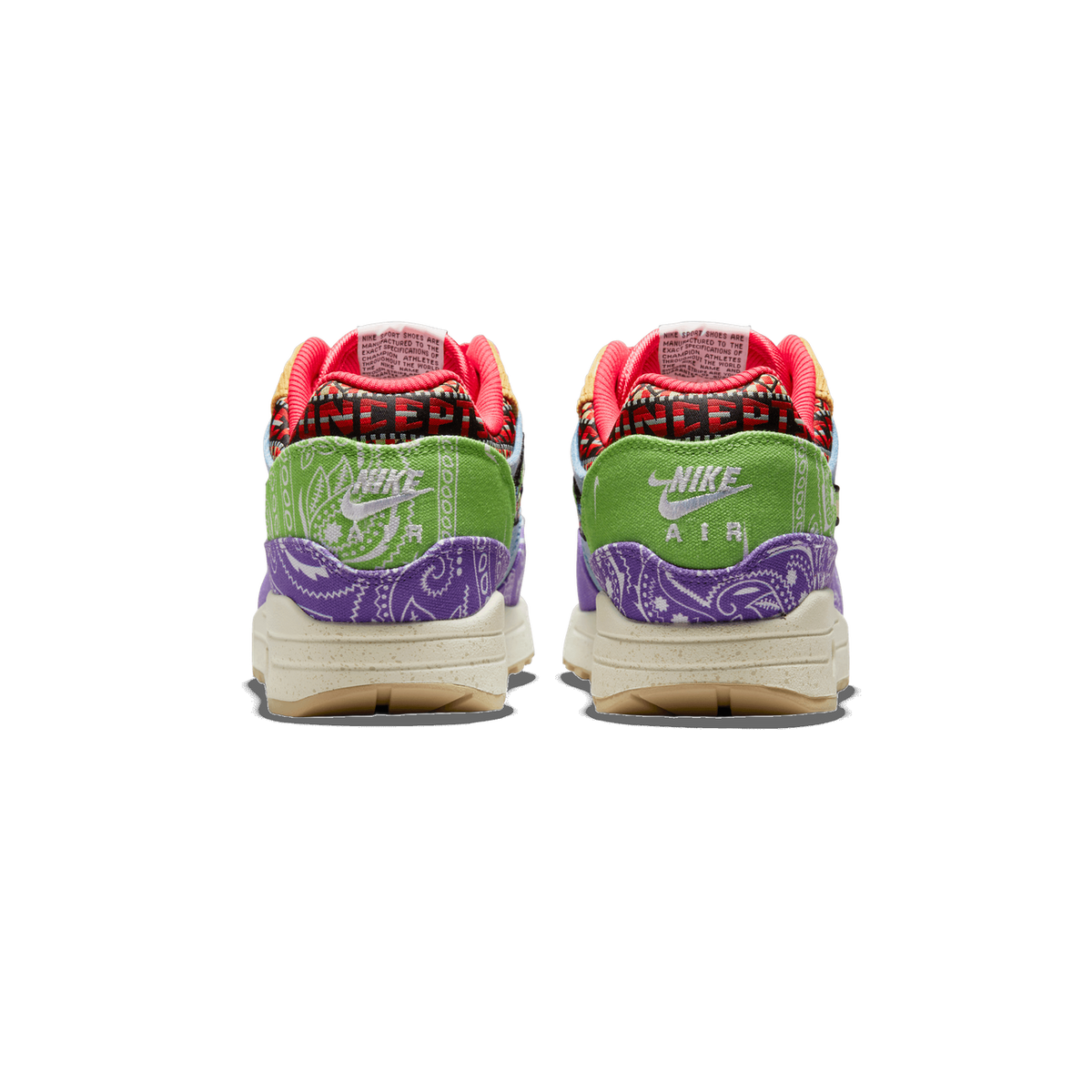 Rear view of a pair of Nike Air Max 1 sneakers with purple paisley heels, green Nike Air logo panels, red Concepts-branded tongues, and cream speckled soles