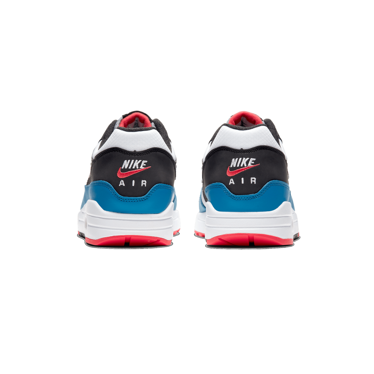 Rear view of a pair of Nike Air Max 1 sneakers with black heel counters, white collars, blue midsoles and red accents, showing the embroidered NIKE Swoosh and AIR lettering on each heel.
