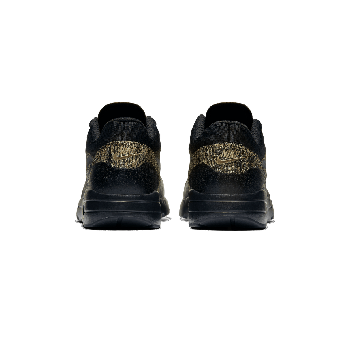 Rear view of a pair of black and olive Nike Air Max 1 Ultra Flyknit sneakers showing the heel tabs with embroidered Nike logos and black soles