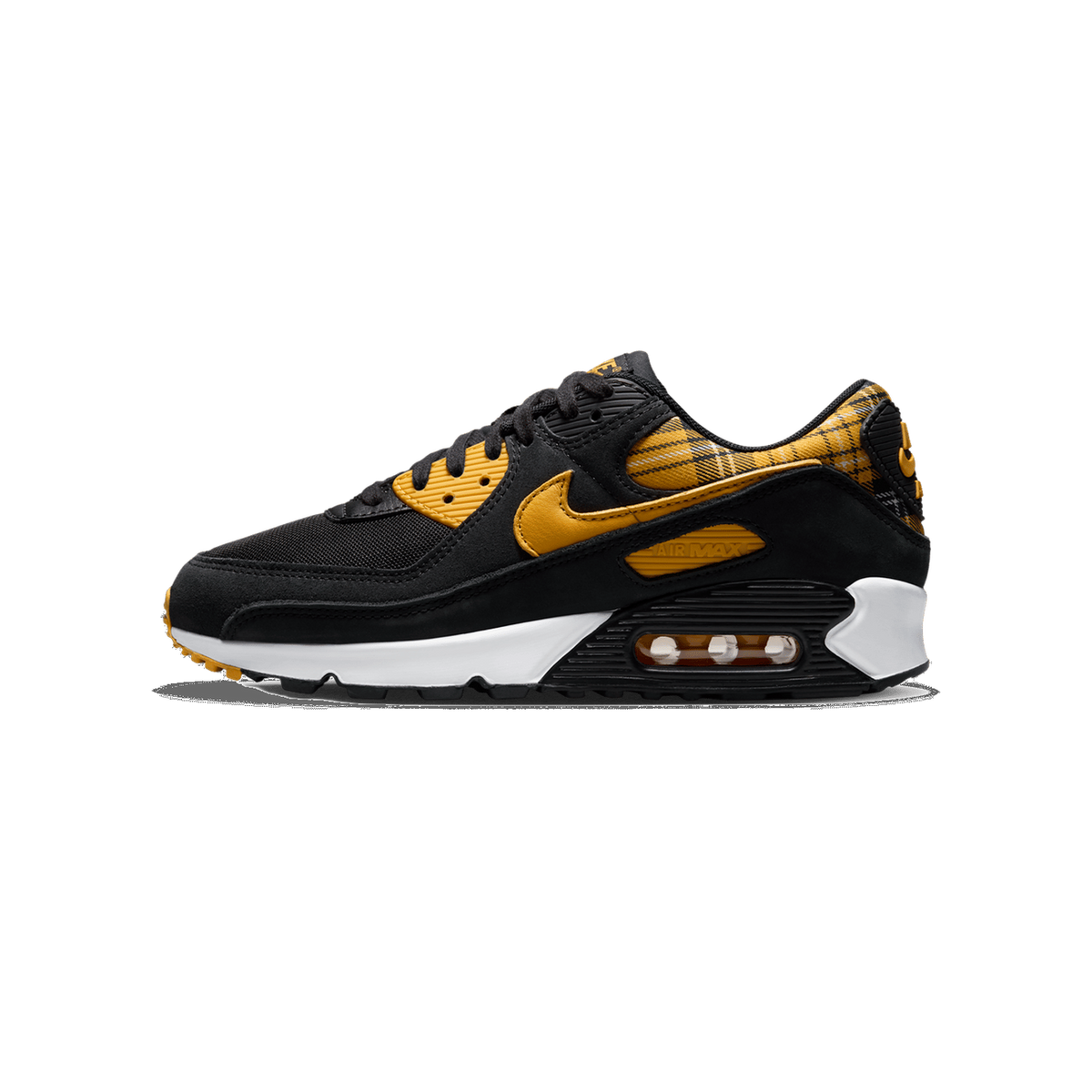 Left Nike Air Max 90 sneaker in black with yellow ochre swoosh and plaid heel accents, white midsole, shown from the outside with toe pointing left.