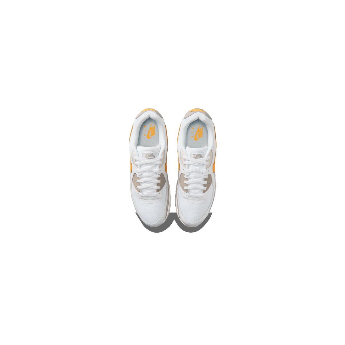 Top-down view of a pair of white Nike Air Max 90 sneakers with gray overlays, orange Swoosh logos, and orange Nike Air branding on the insoles, toes pointing upward and downward with laces facing each other