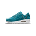 A single teal velvet Nike Air Max 90 sneaker shown from the lateral side with the toe pointing left, featuring silver chain charms hanging from the eyelets and heel area, a white midsole, and a visible Air unit in the heel.
