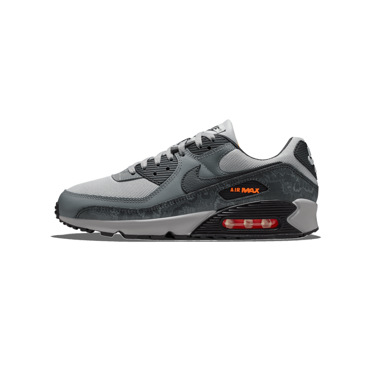 Left Nike Air Max 90 sneaker in grey and black with crackle texture, orange Air Max branding, and visible red-tinted air unit, shown from the side with toe pointing left.