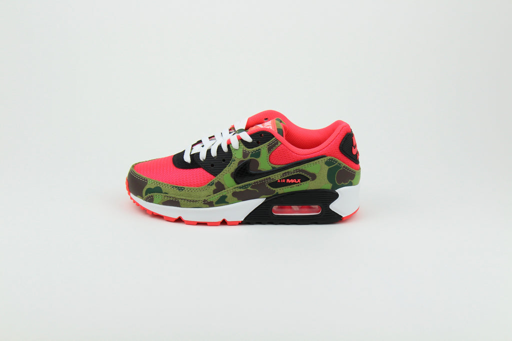 Close-up of Nike Air Max 90 'Reverse Duck Camo' sneaker, featuring bold reverse camo pattern, vibrant color accents, and signature Air cushioning, ideal for fashion-forward sneaker enthusiasts and collectors.