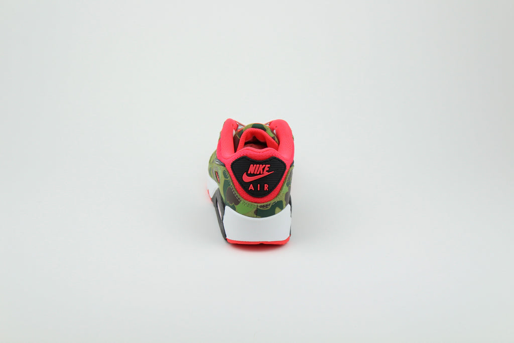 Close-up of Nike Air Max 90 'Reverse Duck Camo' sneaker, featuring bold reverse camo pattern, vibrant color accents, and signature Air cushioning, ideal for fashion-forward sneaker enthusiasts and collectors.