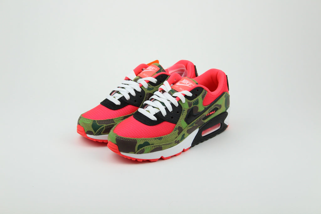 Close-up of Nike Air Max 90 'Reverse Duck Camo' sneaker, featuring bold reverse camo pattern, vibrant color accents, and signature Air cushioning, ideal for fashion-forward sneaker enthusiasts and collectors.