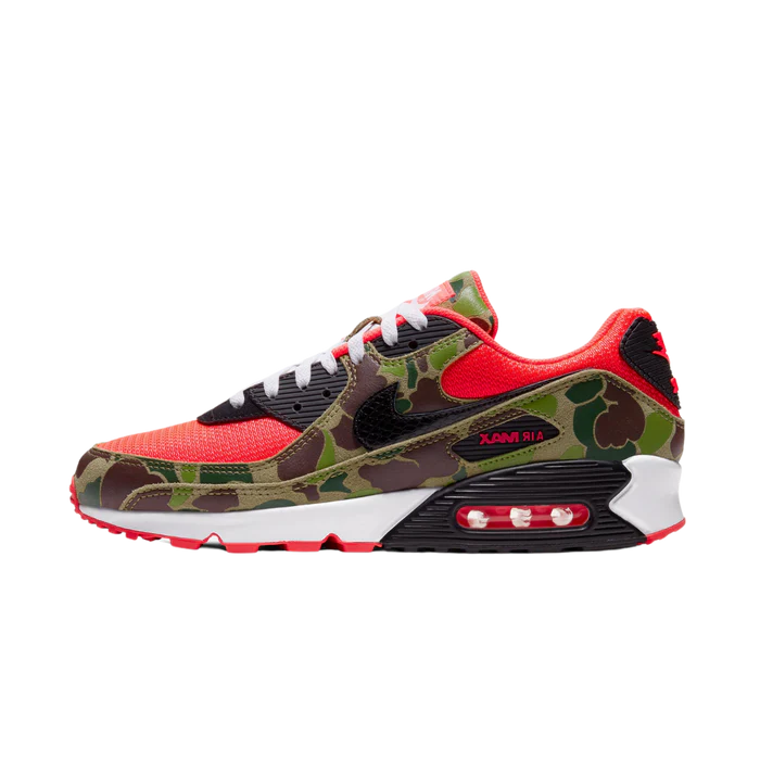 Close-up of Nike Air Max 90 'Reverse Duck Camo' sneaker, featuring bold reverse camo pattern, vibrant color accents, and signature Air cushioning, ideal for fashion-forward sneaker enthusiasts and collectors.