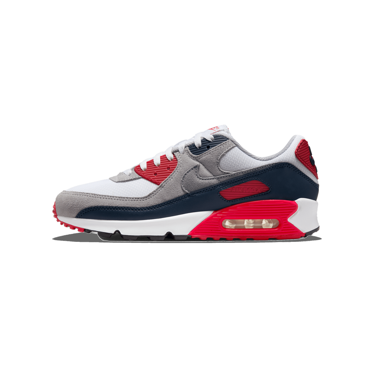 Side view of a white, grey, navy, and red Nike Air Max 90 sneaker with toe pointing left and a visible gray suede Swoosh logo.