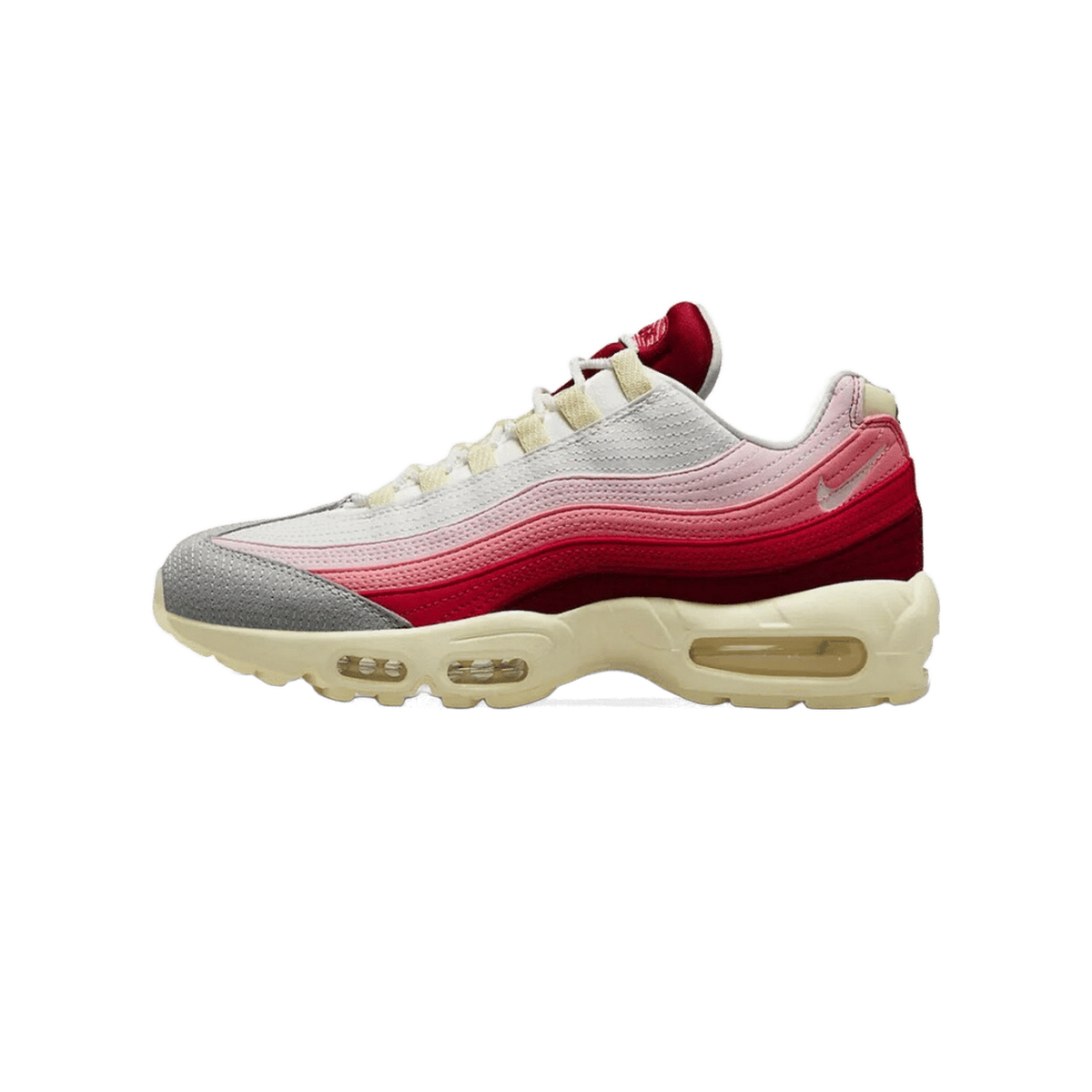 Left Nike Air Max 95 sneaker shown from the outside with toe pointing left, featuring layered red, pink, grey and white panels with a cream midsole and visible Air unit in the heel.