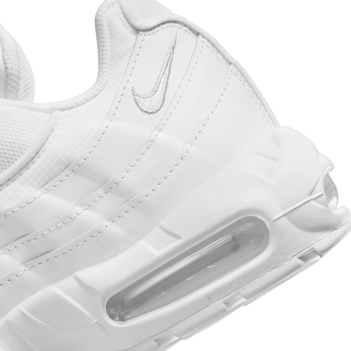 Close-up view of a white Nike Air Max 95 showing the embroidered Swoosh logo and visible Air cushioning unit in the heel.