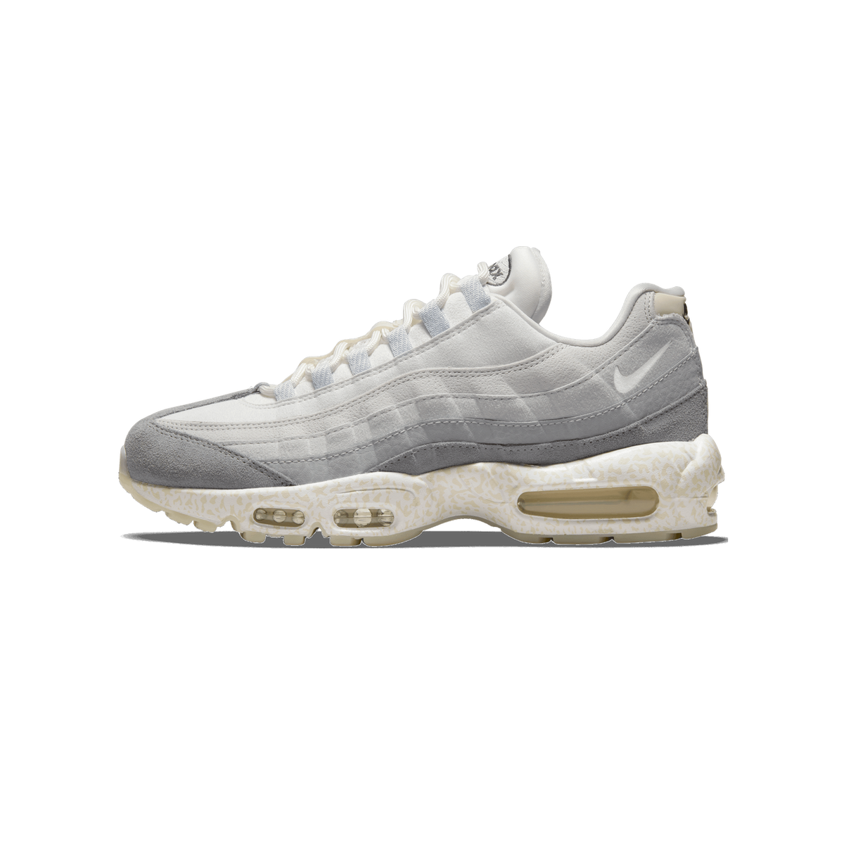 Side profile of a single Nike Air Max 95 sneaker facing left, showing white and light grey leather upper with grey suede toe and heel overlays, a Swoosh on the side, white laces, and a cream speckled midsole with visible Air units.
