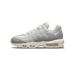 Side profile of a single Nike Air Max 95 sneaker facing left, showing white and light grey leather upper with grey suede toe and heel overlays, a Swoosh on the side, white laces, and a cream speckled midsole with visible Air units.