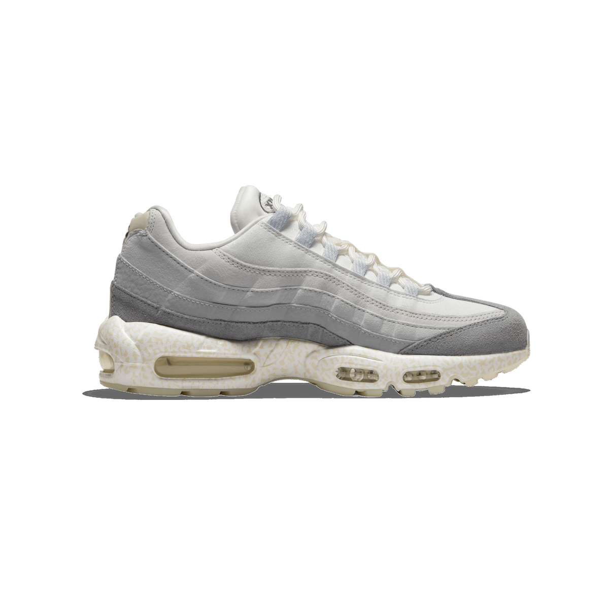 Side profile of a single white, grey and beige Nike Air Max 95 sneaker with the toe pointing left, showing grey suede overlays, white laces and a cream-speckled midsole with visible Air units.