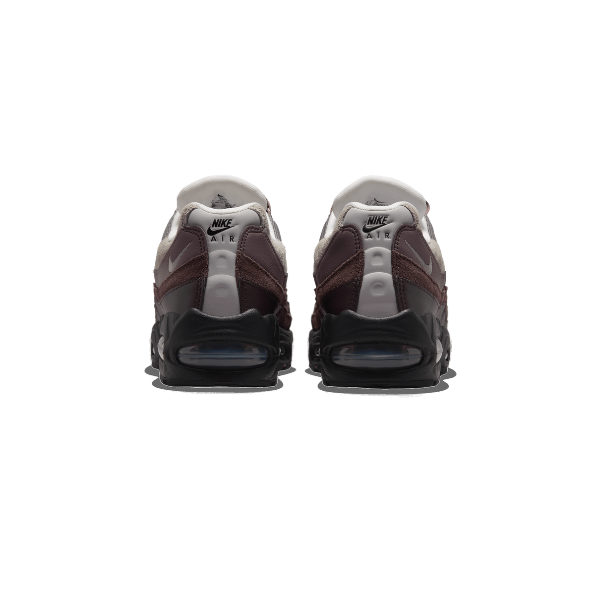 Rear view of a pair of Nike Air Max 95 sneakers in brown and grey with black heel panels and visible Air cushioning units, showing the Nike Air branding on the heel tabs.