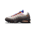 Side view of a grey, white, purple and orange Nike Air Max 95 with visible heel air unit and orange Nike swoosh, toe pointing left.
