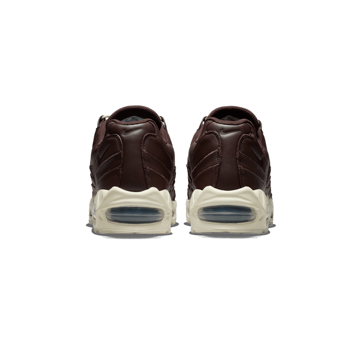 Rear view of a pair of brown leather Nike Air Max 95 sneakers showing the visible air bubble heel units and cream midsoles