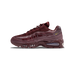 Side profile of a single burgundy Nike Air Max 95 sneaker with the toe pointing left, showing its burgundy mesh and patent overlays, a gold Swoosh on the side, and a visible clear Air unit with AM95 branding in the heel.