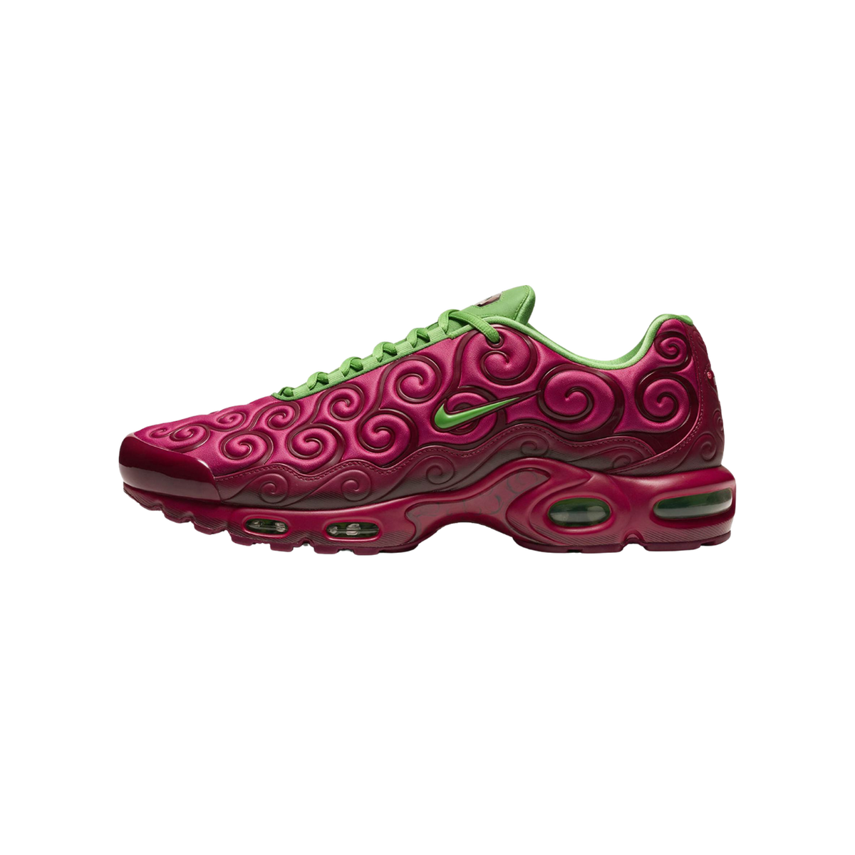 Side view of a left Nike Air Max Plus sneaker in maroon with green spiral swirl patterns, green laces, and green Swoosh logo, toe pointing left.
