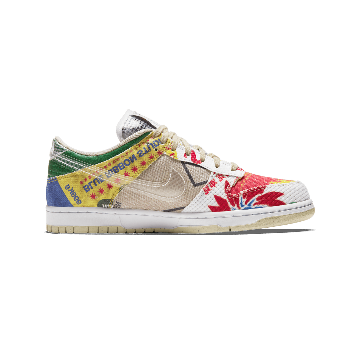 Lateral view of a Nike Dunk Low City Market sneaker with mixed market-bag inspired panels in red, yellow, green, blue and tan, a beige Swoosh, and a white midsole on a cream outsole.