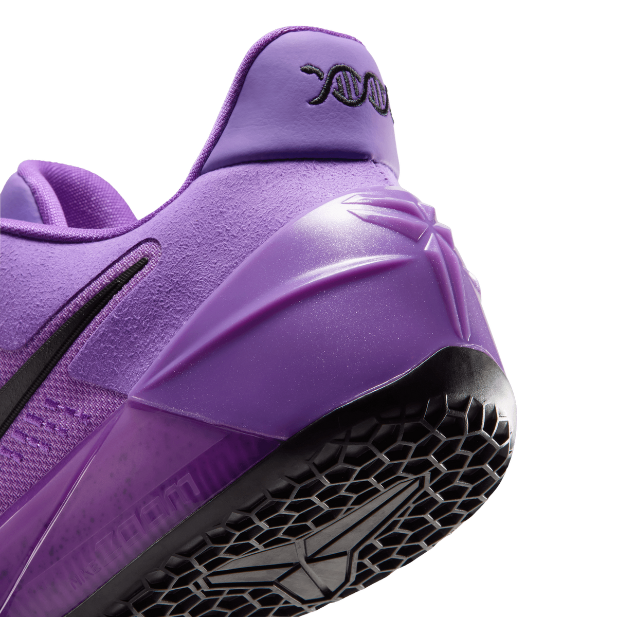 Close-up angled view of the purple Nike Kobe A.D. Protro heel showing the textured heel counter with mamba logo, embroidered DNA design on the pull tab, and black honeycomb outsole tread.