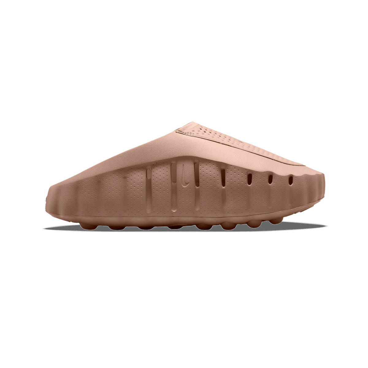 Side view of a tan slip-on molded shoe with a perforated upper, ridged midsole, and Nike swoosh embossed near the heel