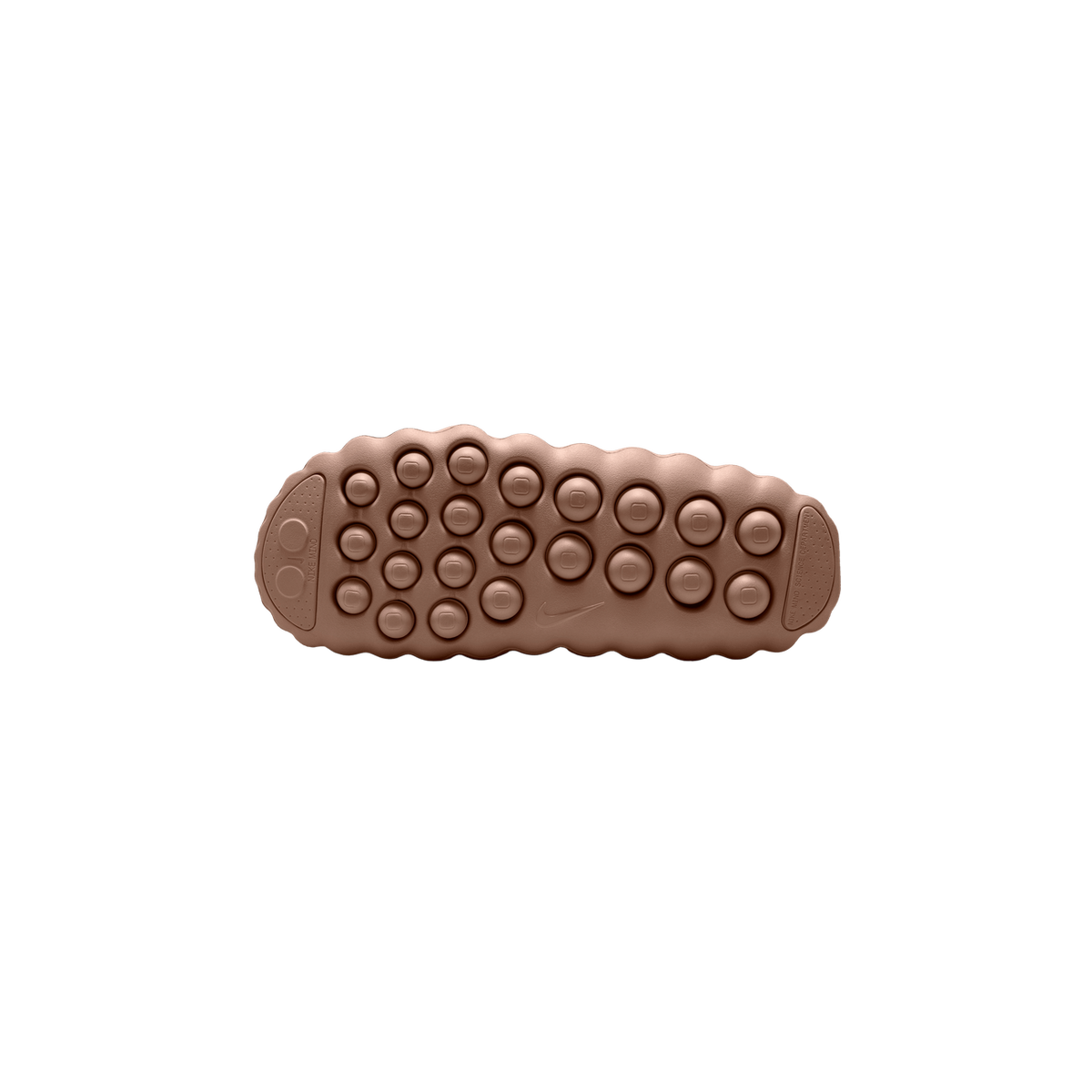 Bottom view of a brown Nike Mind 001 shoe showing a bubble-textured outsole with circular tread nodes and an embossed Nike swoosh.