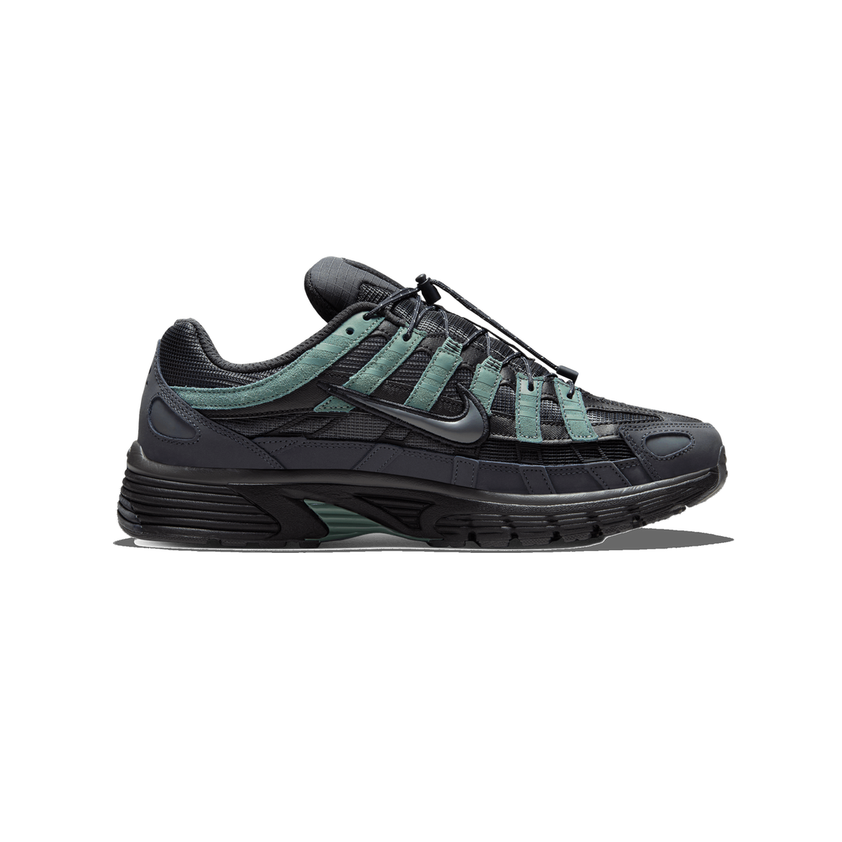 A single Nike P-6000 sneaker in dark anthracite grey and black with green suede overlays, shown from the outside in profile with the toe pointing left and the Swoosh logo visible on the side.