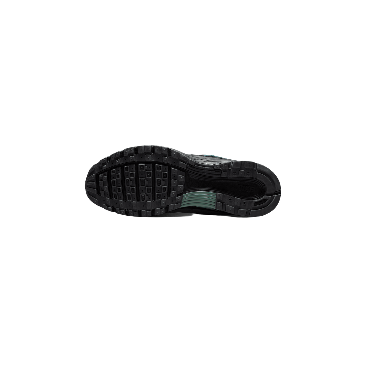 Underside of a dark gray and black Nike P-6000 sneaker showing the multi-lug tread pattern on the sole, with green accents along the midfoot and a small NIKE logo on the arch.