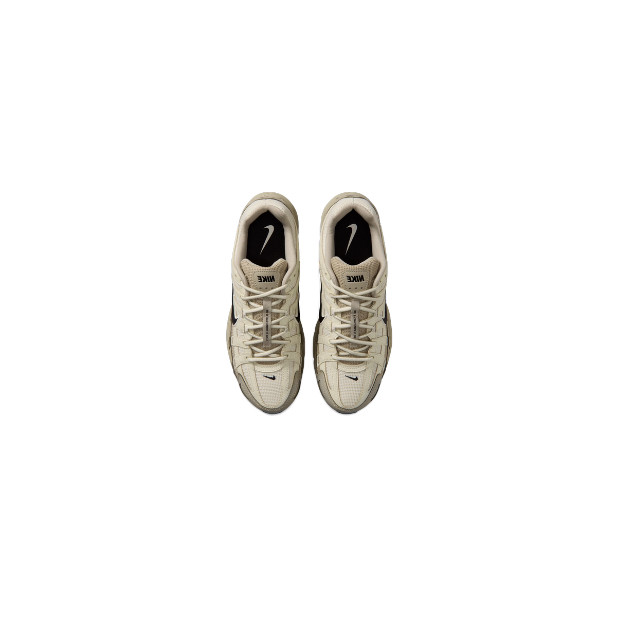 Top-down view of a pair of beige Nike P-6000 sneakers with black swoosh logos, black interior tongues featuring white swoosh branding, and beige laces with a tag reading Bowerman Series.