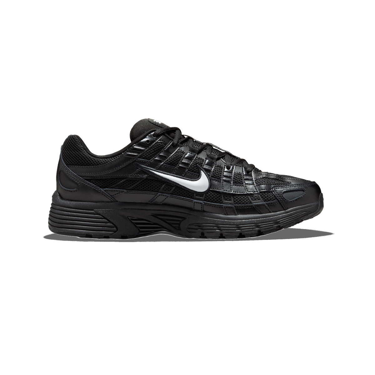 A single black Nike P-6000 sneaker shown from the outside lateral side, toe pointing left, with a white Swoosh logo on the mesh and leather upper and a black rubber sole.