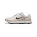 Left Nike P-6000 sneaker in white and light brown with toe pointing left, showing the dark Swoosh logo and chunky layered sole.