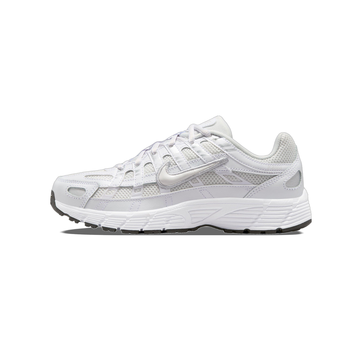 Side view of a white and grey Nike P-6000 sneaker with toe pointing left, showing mesh panels, embroidered swoosh, and chunky white midsole with black outsole