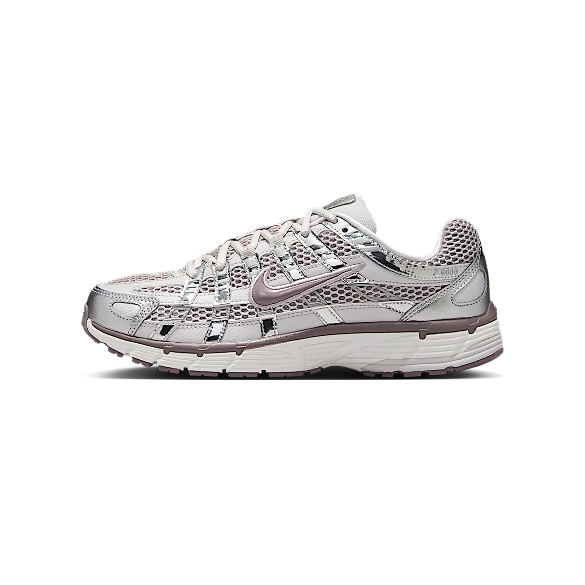 Side view of a grey and purple Nike P-6000 sneaker with metallic silver overlays, mesh upper, and a chunky white midsole, toe pointing left.