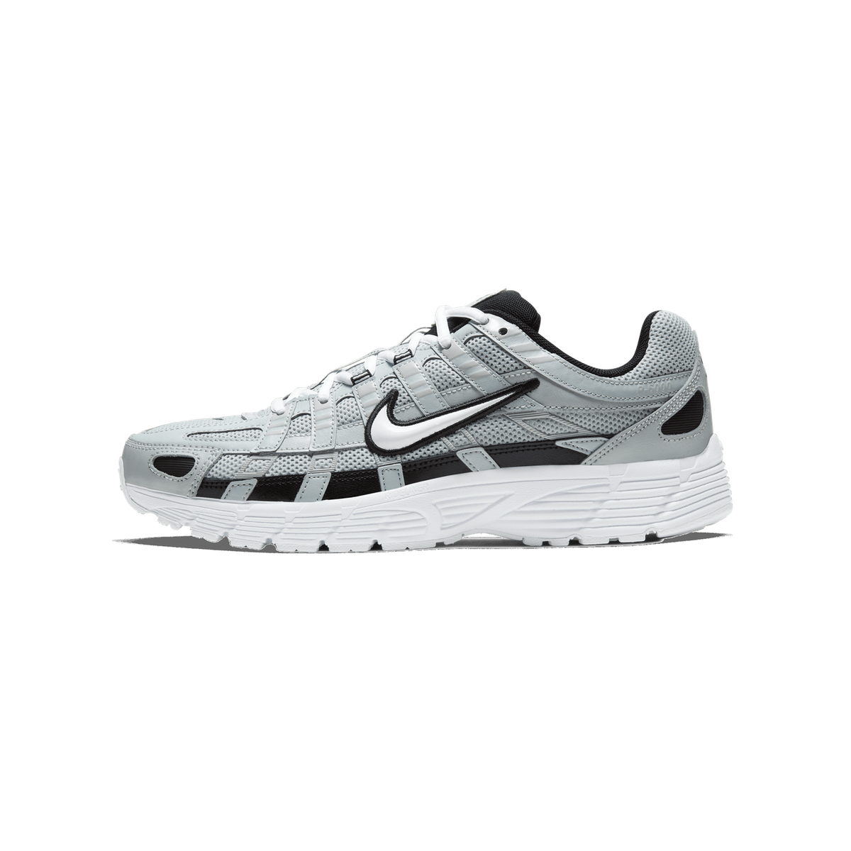 Side profile of a silver and grey Nike P-6000 sneaker with a white midsole and black accents, toe pointing left, showing the embroidered Swoosh logo on the side.