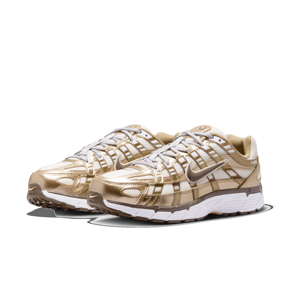 Front three-quarter view of a pair of Nike P-6000 sneakers with metallic gold overlays, white mesh upper, and white midsole with brown accents.