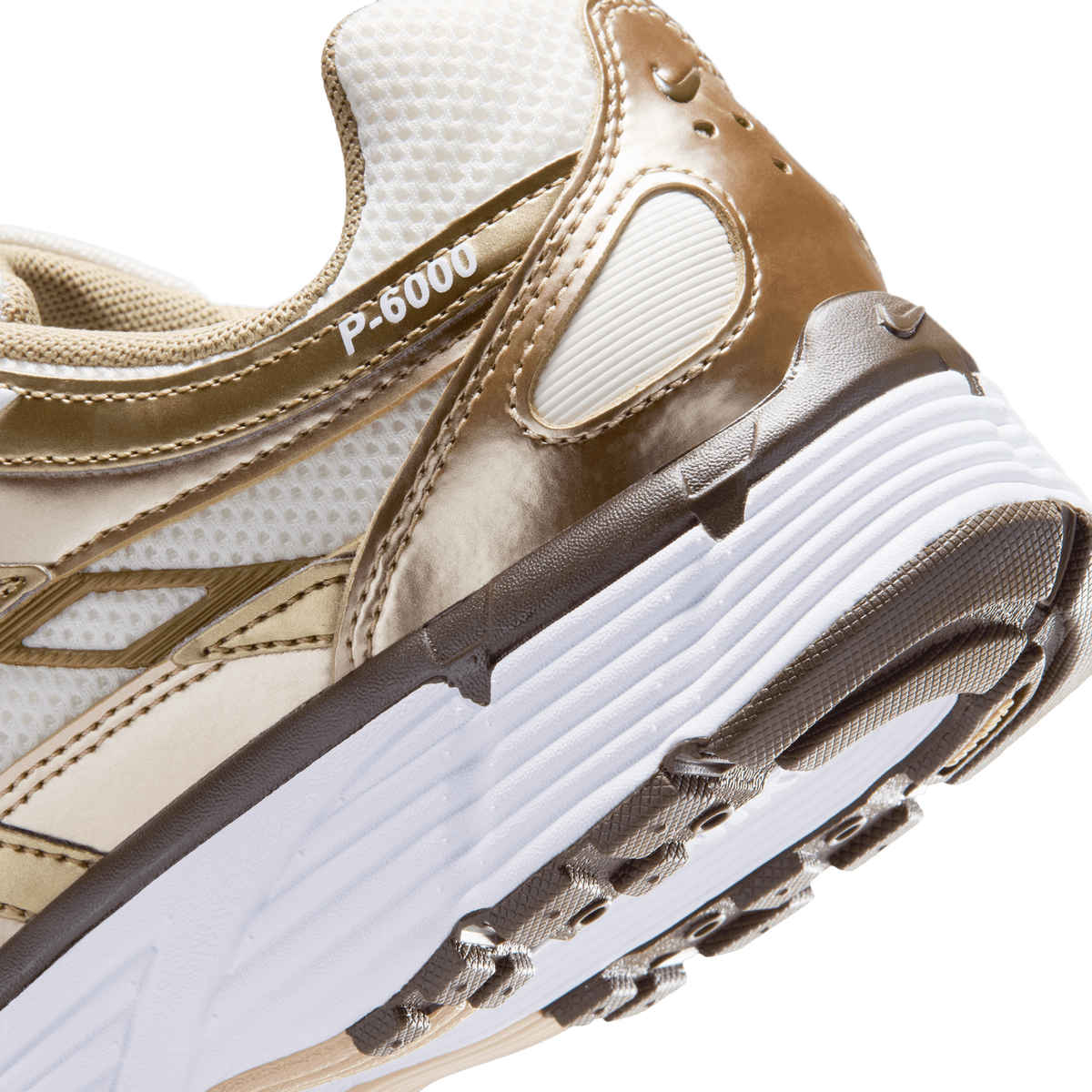 Close-up angled view of a Nike P-6000 sneaker in sail, linen, and dark hazel tones showing the midsole texture and side P-6000 branding.