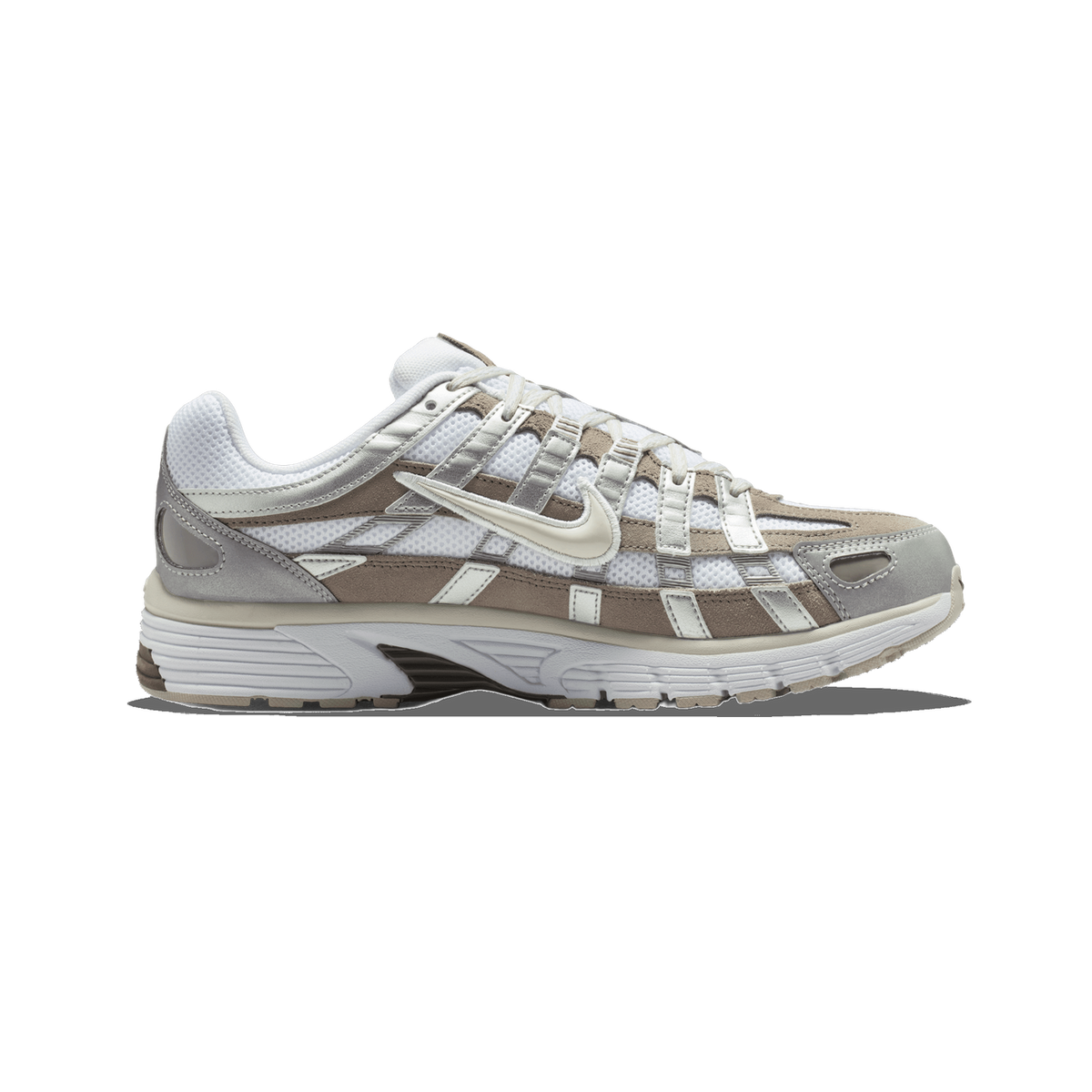 Side view of a Nike P-6000 sneaker with toe pointing left, showing white mesh panels, taupe suede overlays, silver accents, and a cream swoosh logo.