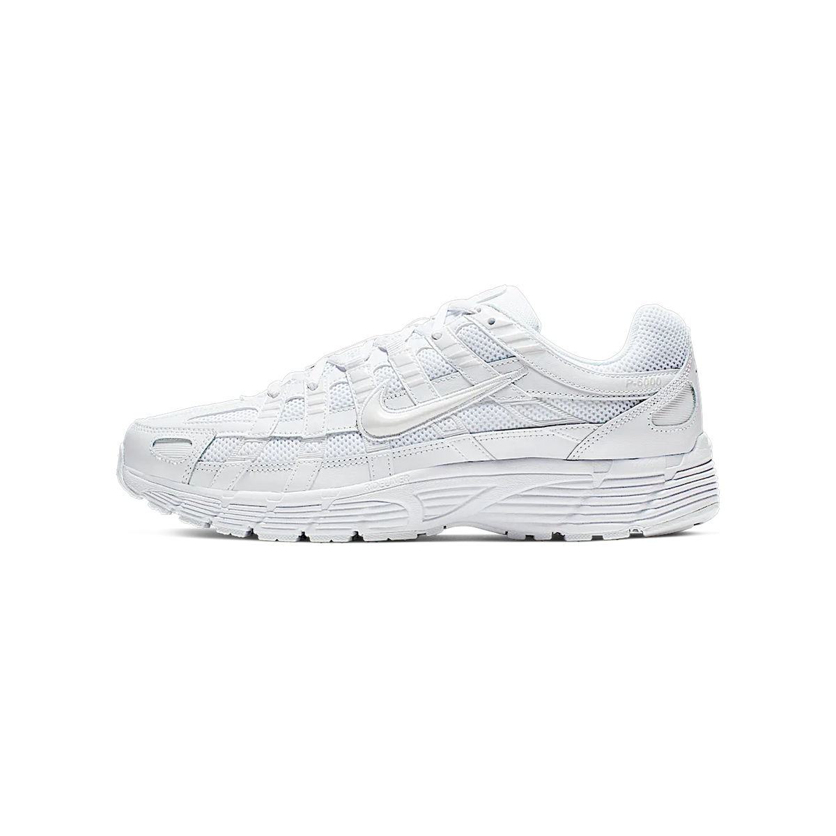 Side view of a white Nike P-6000 sneaker with toe pointing left, showing layered mesh and leather panels, chunky ridged sole, and a white Swoosh logo.