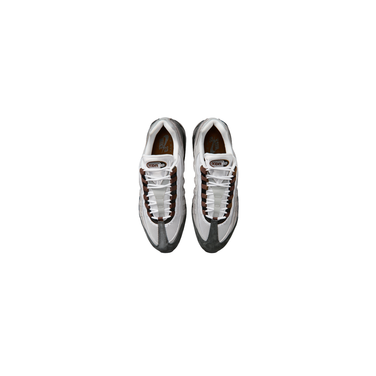 Top-down view of a pair of Nike SB Air Max 95 sneakers in white, gray and brown with black lace stripes and gray suede toe and heel panels.
