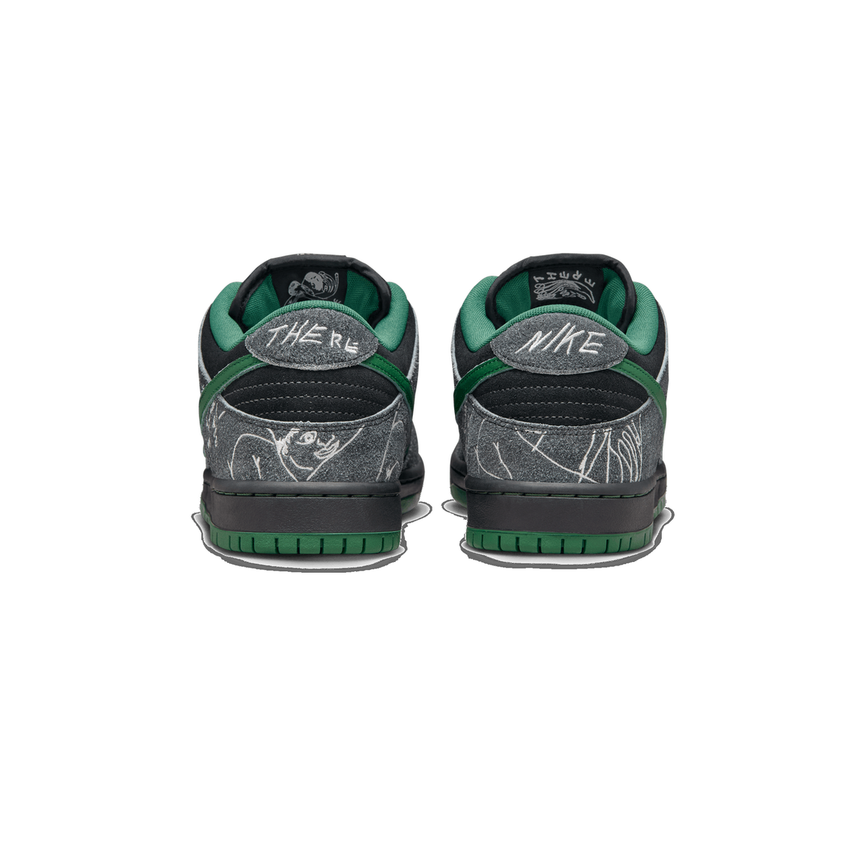 Rear view of a pair of Nike SB Dunk Low There sneakers in grey suede with black overlays and green accents, featuring hand-drawn style graphics and 'THERE' and 'NIKE' text on the heel tabs