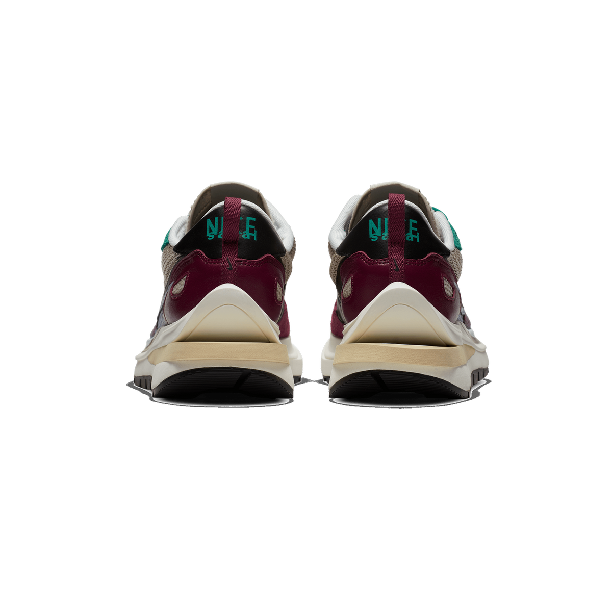 Rear view of a pair of Nike sacai sneakers on a white background, showing the heel tabs with teal Nike and sacai logos, burgundy and taupe panels, and cream midsoles with black rubber outsoles.