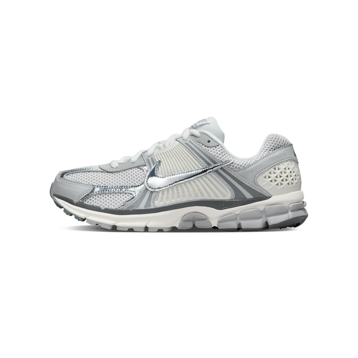Side view of a white and gray Nike Zoom Vomero 5 sneaker with a metallic silver swoosh logo and chunky ridged sole, toe pointing left.