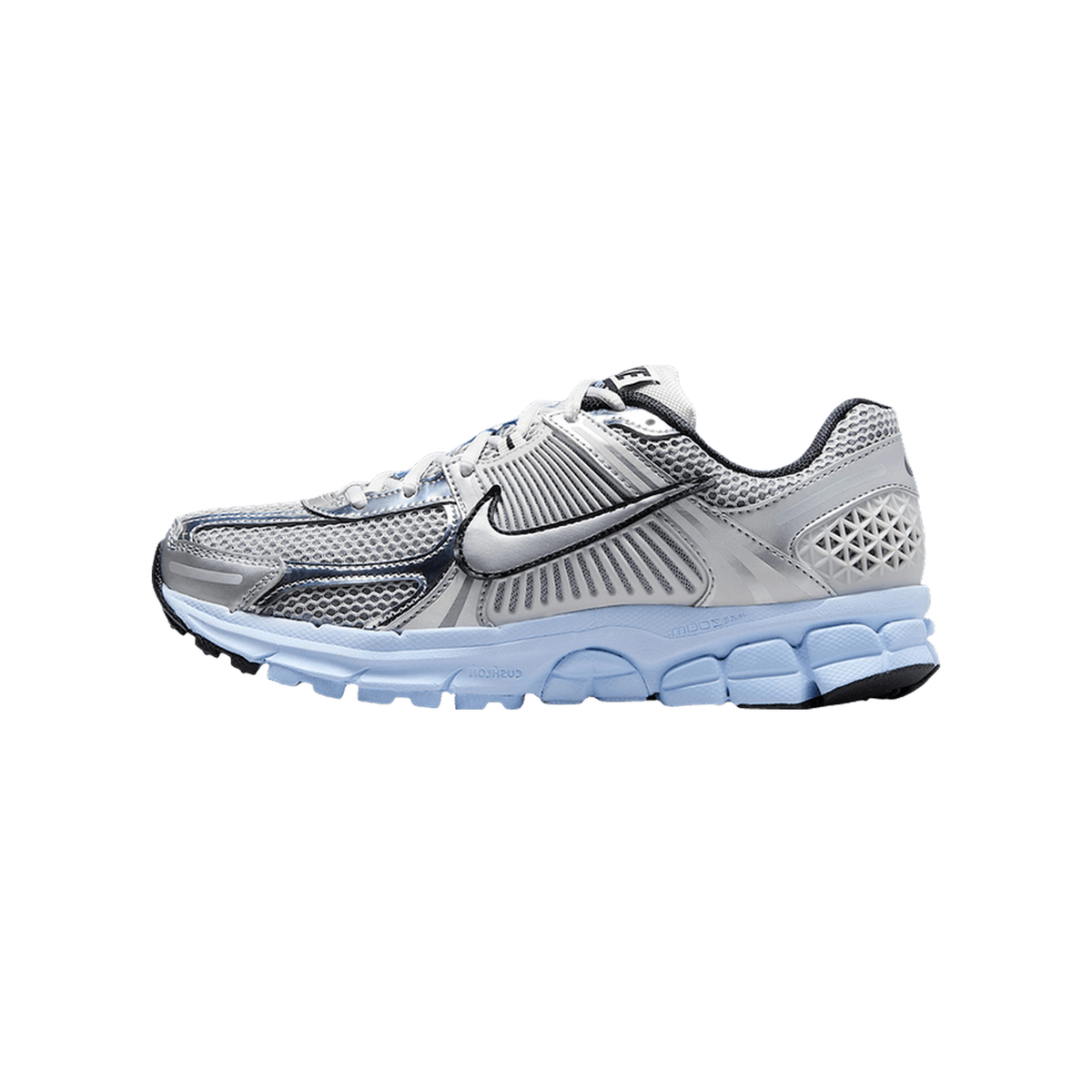 Side view of a silver and white Nike Zoom Vomero 5 running shoe with a light blue midsole and dark navy accents, toe pointing left.