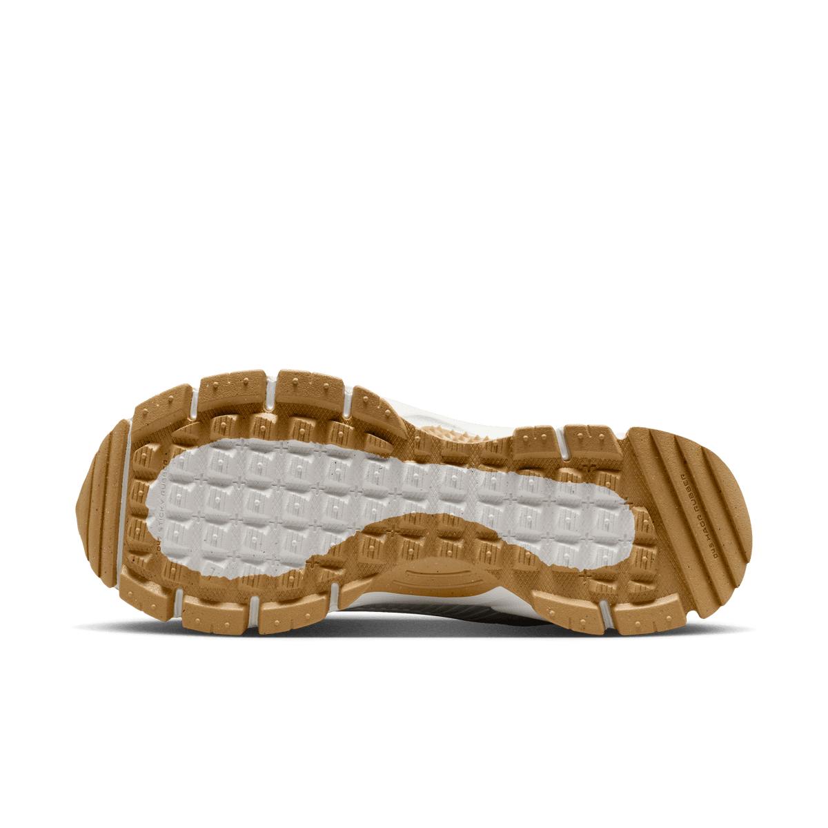 Bottom view of a Nike Zoom Vomero 5 sneaker showing a chunky lugged gum rubber outsole with a white textured midfoot section.